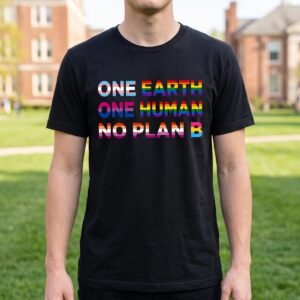 Student on a campus lawn wearing a black tee printed with three lines of heavy capitals, One Earth One Human No Plan B, each word in a different rainbow gradient